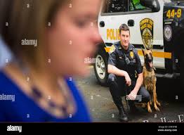Lynsay Fox, the widow of slain Plymouth Township officer Bradley Fox speaks  in view of a photograph of her husband during a news conference Monday,  Sept. 8, 2014, in Philadelphia. Fox is