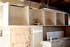 First up, frame up the floor and line the area with plywood. How To Build A Diy Wall Mounted Garage Cabinets Thediyplan
