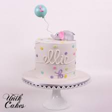 Birthday Cake With Cake Pops On Top A Sweet Elephant Lays On Top Of A White Cake With Pastel Polka Dots And Bows With A Balloon Wit Half Birthday Cakes 1 Year Old Birthday Cake Birthday Cake Pops