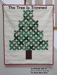 Quilted wall hanging, houses and flowers pattern. The Tree Is Trimmed Mini Quilt Moda Bake Shop Mini Quilt Christmas Quilts Christmas Tree Quilt
