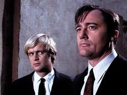 Middle right, jolly professor-type with a monocle.