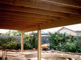 A Solid Roof Patio Cover Under Construction Curved Pergola Wooden Patios Pergola