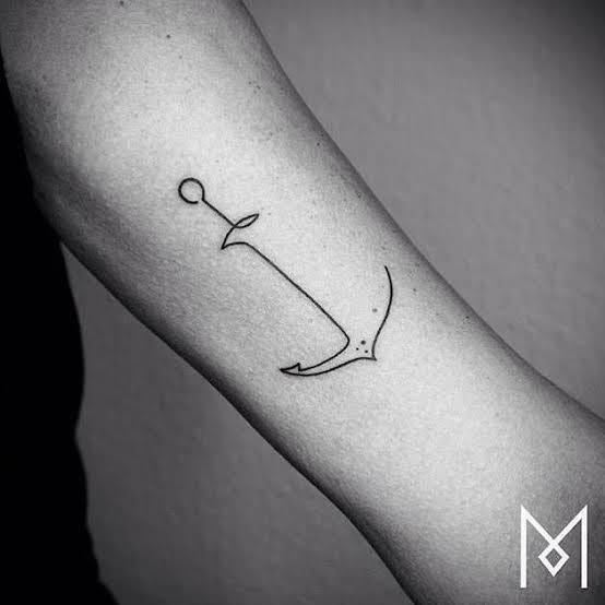 Continuous line anchor tattoo on the left bicep.