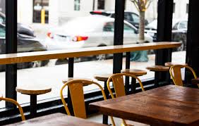 Early 20th century american american craftsman coffee and cocktail tables. High Resolution Color Digital Photo Of A Row Of Rustic Restaurant Style Tables Vintage Chairs Next To Bar Seating By A Window On A City Street At A Cafe By Dorey