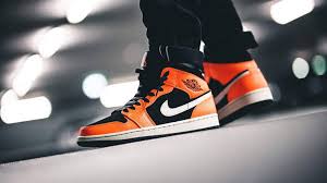 Dressed in a an orange, white, and black color scheme. Jordan 1 Mid Black Orange Where To Buy 554724 062 The Sole Supplier