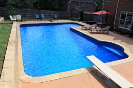 Bright Blue Vinyl Pool With Diving Board And Ledge Vinyl Pool Backyard Pool Pool Landscaping