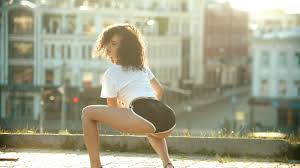 A young woman twerking on the roof