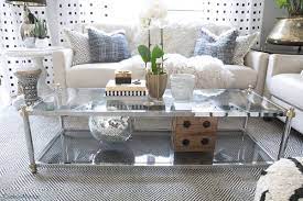 There are two topiary spheres with unique textures, and an antique ceramic pitcher is used as a vase for a bouquet of fresh. How To Style A Two Tier Coffee Table Cuckoo4design