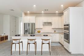 A seafoam green backsplash proves a perfect backdrop for the natural wood flooring, ceiling beams, and island in this cozy kitchen. Expert Backsplash Ideas To Complete Your Luxury Kitchen Build Beautiful