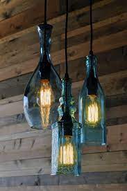 Emery recycled glass chandelier a handcrafted recycled glass chandelier is a unique lighting solution for the living room, kitchen or dining room. Recycled Bottle Chandelier By Moonshinelamp On Etsy 395 00 Bottle Chandelier Bottle Lights Old Wine Bottles