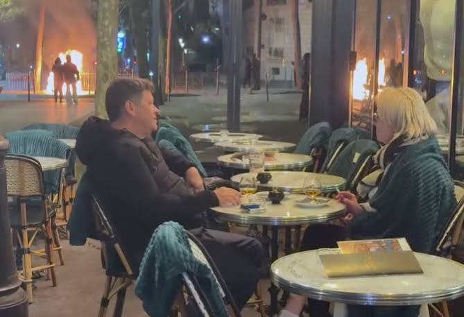 Couple in France filmed enjoying a drink as Paris burns