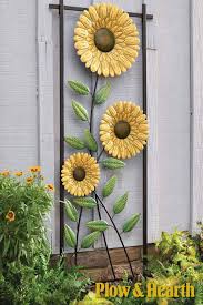 They attract bees, squirrels, and birds with their sweet pollen and a multitude of edible seeds. Sunflower Trellis Makes A Bold Statement Sunflower Trellis Sunflower Wall Decor Sunflower Garden