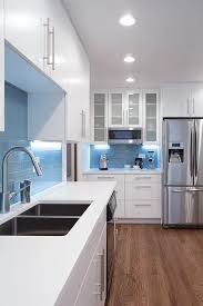 The kitchen uses simple paneled cabinets in pure white, with an overhead cabinet featuring glass cabinet doors. Pin On Chi Renovation And Design