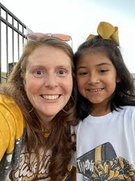 Cheerleaders perform at football game for seniors