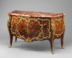 A low cabinet or chest of drawers, often elaborately decorated and usually standing on legs or short feet. Commode Wiktionary