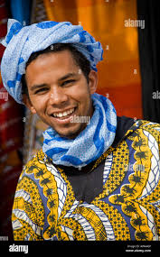 Touareg Nomad musician with Moroccan Carpet in Essaouira Morocco North  Africa smiling smile Stock Photo