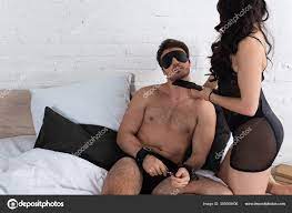 Woman Pointing Spanking Paddle Man Blindfold Handcuffs Bed Bedroom Stock  Photo by ©IgorVetushko 355609406
