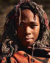 The village of Mokongoa, nestled over 2000 meters high. A place of  remarkable tranquility and authenticity. During my visit, I photographed a  village youth. His deep and wise gaze revealed a surprising