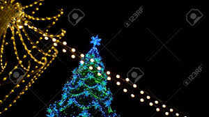 Get it as soon as fri, jun 11. View Of Christmas Tree Decorated Large Luminous Multi Pointed Blue Stars And Yellow Balls Through Garland Of Yellow Lights Encircling City Square Outdoor Stock Photo Picture And Royalty Free Image Image 150127842