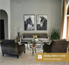 Lined with gray mirrored circles pillows and a light gray velvet barrel back chair facing a glass and nickel hexagonal coffee table, bernhardt paxton coffee table, placed atop a gray geometric wool rug. Z Gallerie Pascual Coffee Table Living Room Redo Stylish Home Decor Affordable Home Decor