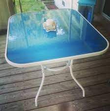 After the pale blue inset on each table was dry for >24 hours, i glued down rows of the glass gems using a white craft glue. New Painting Glass Table Top Fun Ideas Patio Furniture Makeover Glass Top Table Glass Kitchen Tables