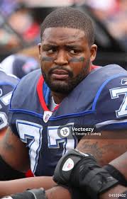 Miami Dolphins wide receiver Brandon Marshall (right) runs with the ball  and gets blocked by Buffalo Bills strong safety Donte Whitner (left) at  Ralph Wilson Stadium. 64558515 Editorial Image