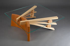 Tanoto Coffee Table Square Hardwood Glass Coffee Table Seth Rolland A beautiful thick glass top and two interlocking wood base pieces in walnut finish.