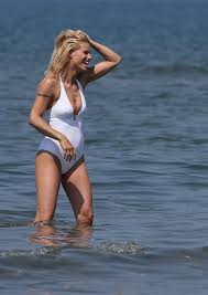 MICHELLE HUNZIKER in Swimsuit and Bikini at a Beach at Forte Dei Marmi –  HawtCelebs
