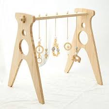 The Best Wooden Baby Activity Gyms To Get Your Baby Moving If You Re Looking For The Best Wooden Baby Acti In 2020 Baby Activity Gym Wooden Baby Gym Wooden Baby Toys