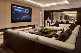 Large U Shaped Sofa Around Central Coffee Table Large Tv Set Into The Wall With Long Fireplace Contemporary Family Rooms Home Theater Rooms Family Room Design