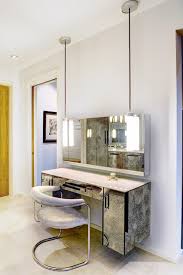 A contemporary and modern bedroom vanity table that features a solid construction with simple lines and white finish that is neutral, so it looks very nice in any bedroom decor. 8 Modern Dressing Tables For Unflouncy Women