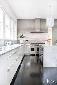 Modern White Kitchen With Black Lacquered Oak Floors White Modern Kitchen Modern Black Kitchen Kitchen Flooring