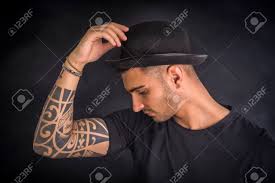 They aren't just desaturated versions of normal colour images. Handsome And Stylish Young Man With Black Bowler Hat And T Shirt Cool Tattoos On Arms Profile View Stock Photo Picture And Royalty Free Image Image 57878910