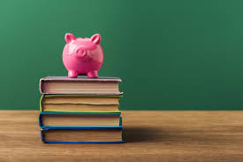 Pretty purple piggy bank is a fun way to introduce children to money and spending. Pink Piggy Bank On Books Wooden Table And Green Background Free Stock Photo And Image