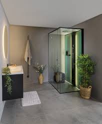 This stylish steam room has white corian benches and large format tiles to the walls. New Slimline Shower Column And Steam Shower Room Enclosure From Tylohelo