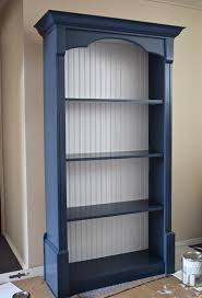 Have a bookcase that you want white? Navy Blue And White Painted Bookcase