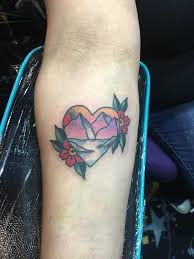 This is a very different tattoo and there is obviously a lot of love for the dog in this tattoo. Mountain Scene Inside Heart W Flowers By Cody Hennings Tattoonow