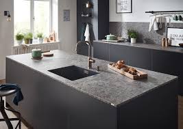 A double thick slab of cultured white marble with a contemporary straight edge profile cradles a modern undermount rectangular ceramic sink. Laminate Worktops Laminate Kitchen Worktops Lechner