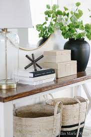 When decorating a console table keep in mind to add height, use repeating colors and designs, use odd groupings and keep things balanced with color and height. Entryway Styling Ideas For A High End Look Caitlin Marie Design