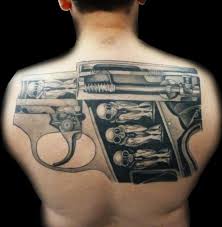 The tattoo with a gun like this is special and will turn heads wherever you go. Fantasy Back Gun Tattoo By Medusa Tattoo