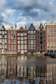 Amsterdam's stately canal houses are integral to the city's heritage and give a glimpse into life in the once homes for the wealthy, many canal houses are now open as museums, offices and hotels. Terraced Dutch Style Historic Houses With Reflections On A Canal Water In Amsterdam Netherlands Dutch Houses Amsterdam Houses Dutch House