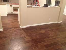 This price includes tearing up old tile, disposing of materials, prepping the surface and installing a new covering. Ceramic Tile Floor Looks Like Wood Wood Tile Small Basement Remodeling Faux Wood Tiles
