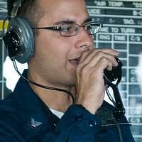 Airman Dontavious Johnson, assigned to the Cougars of Electronic Attack  Squadron (VAQ) 139, cleans the canopy of an EA-18G Growler