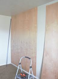 With the help of hanging hardware designed for pegboards, you can decorate the wall with photos as well as baskets for dvds and magazines. Easy Diy Plywood Panel Wall On A Budget Wall Paneling Diy Plywood Wall Basement Wall Panels