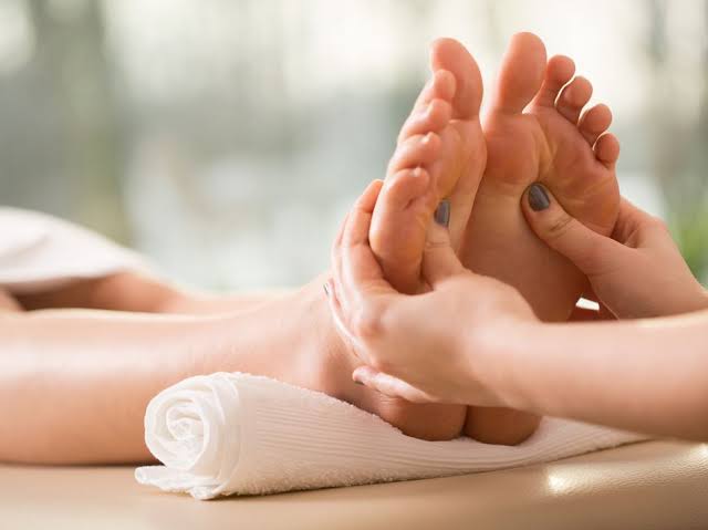 therapist applying pressure foot reflexology