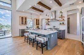 Tray ceiling with wood beams. Exquisite Kitchen With Large Island And Tray Ceiling With Wood Beams Stock Photo Picture And Royalty Free Image Image 152483082
