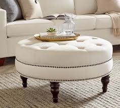 Base is made of metal and fitted with wooden top. Martin Upholstered Round Ottoman Pottery Barn