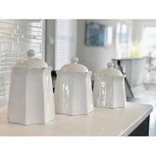 White kitchen canisters with wood lids and white bumps. Farm Animal Canisters Wayfair
