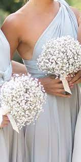 The bride carried a pink, yellow, and purple arrangement of wildflowers, while the bridesmaid bouquets of simple baby's breath completed the perfect summer look at this chicago wedding. Spring Wedding Wedding Bridesmaids Wedding Bouquets Bridesmaid Bouquet