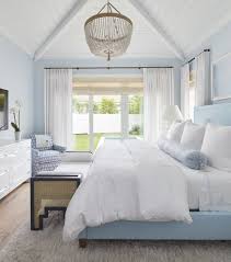 Stylish grey and white nordic style bedroom.the predominantly white artwork helps lighten up the stone grey walls. House Tour A Serene Blue White Beach House Interior White Beach Houses Beach House Interior House Interior